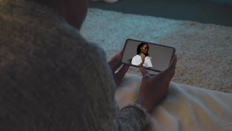 Woman-Lying-On-Bed-At-Home-Looking-At-Music-And-Dance-Video-On-Mobile-Phone